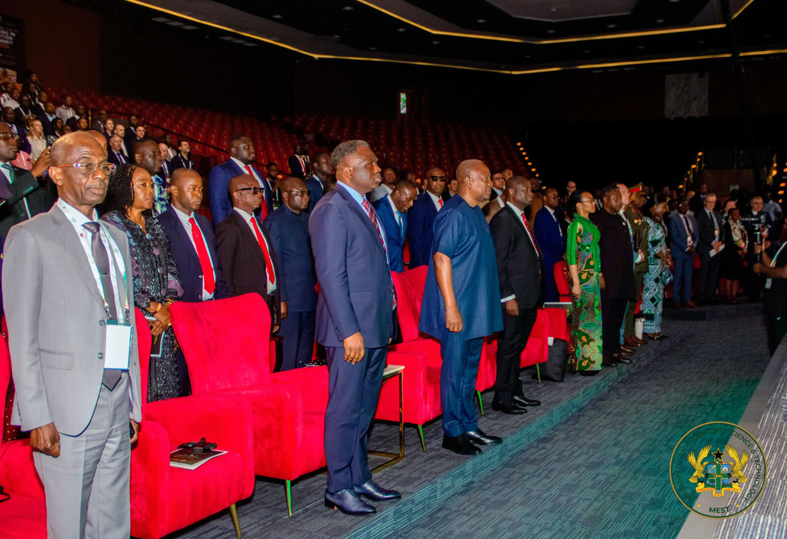 All participants observing the national anthem.