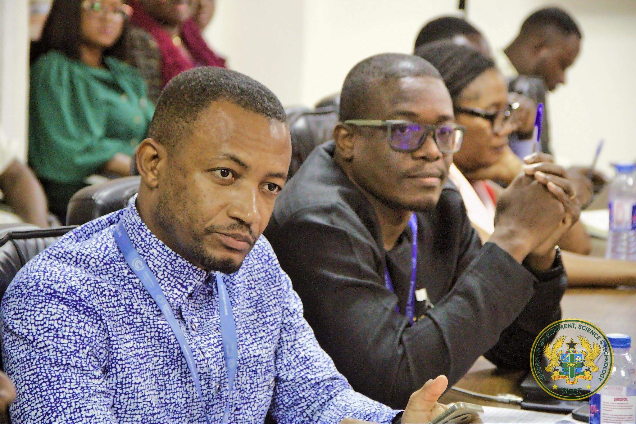 Members of the negotiating team follow proceedings during the briefing.