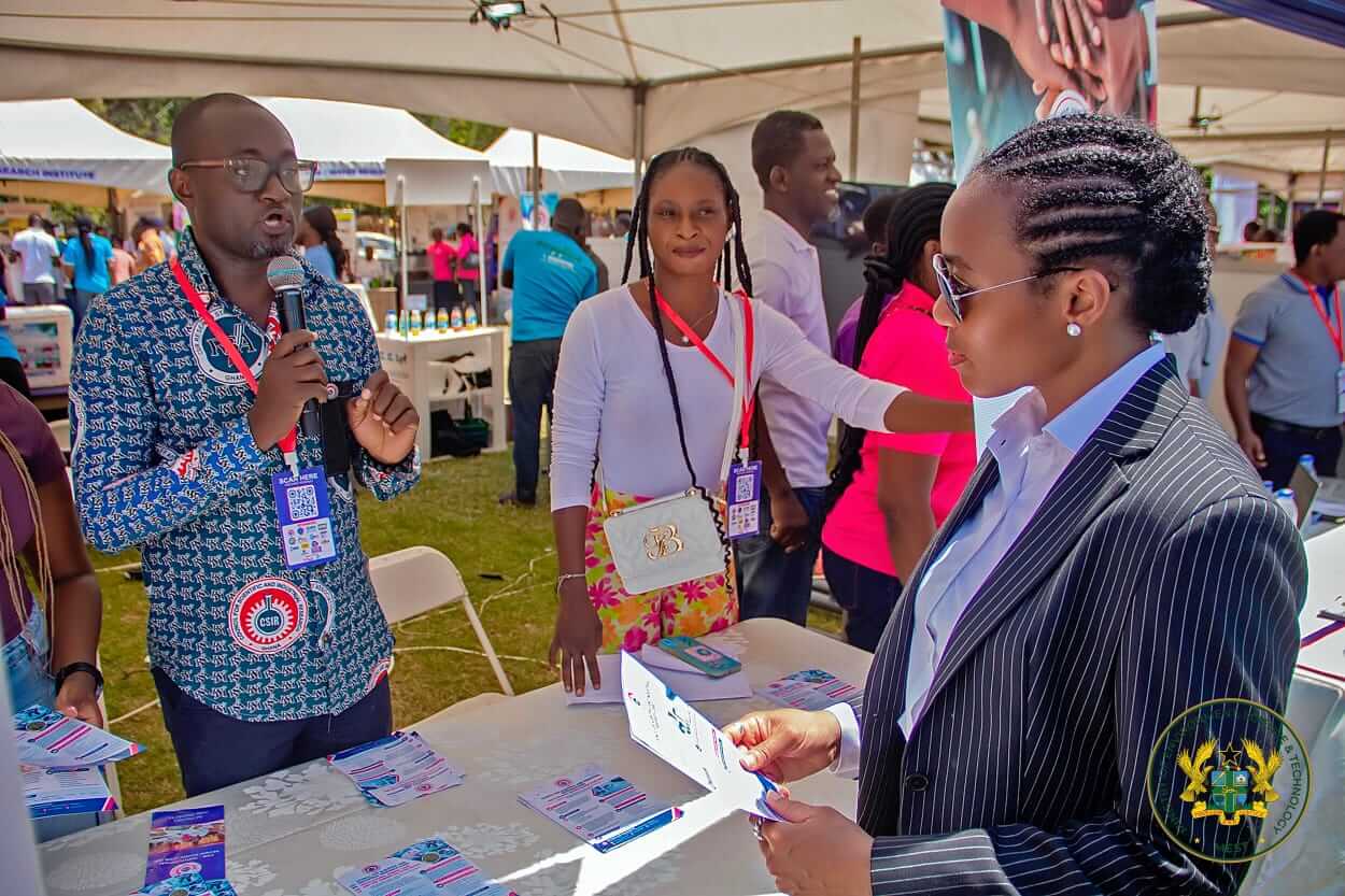 The Minister engages exhibitors at the fair.
